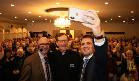 A rabbi, priest and imam taking a selfie